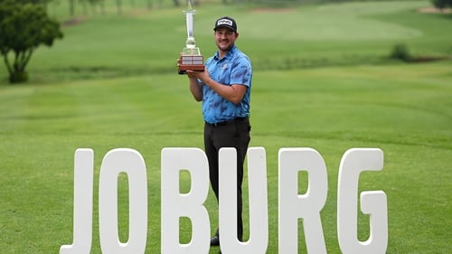 Thriston Lawrence hoists the Joburg Open trophy aloft