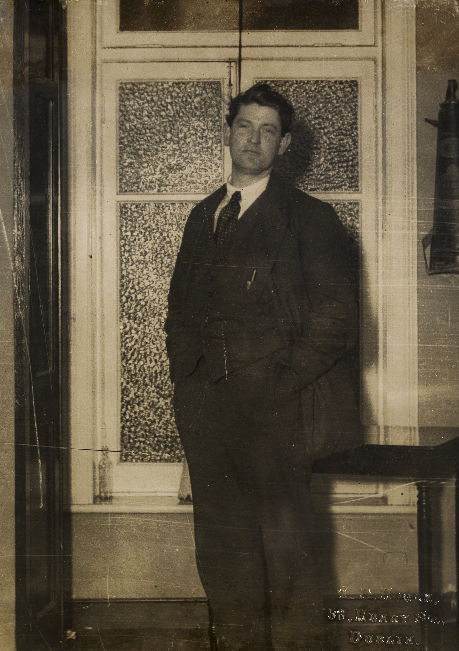 Image - An exhausted Michael Collins photographed at the Gresham Hotel, the night of the vote to ratify the Treaty. Unusually for Collins, he is happy to be photographed at an unguarded moment. Credit: National Library of Ireland
