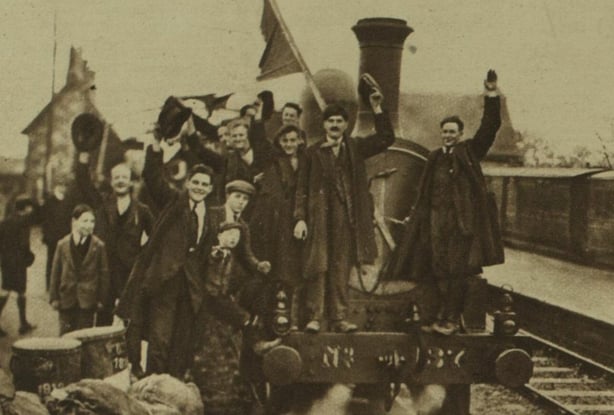 Released prisoners from Maryborough internment camp celebrating while standing on an engine. Photo: Illustrated London News, 17 December 1921