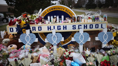 Tributes continue to be left outside Oxford High School in Michigan today