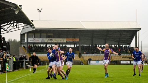 Derrygonnelly Harps and Dromore in action in front of the re-located Nally Stand in Carrickmore