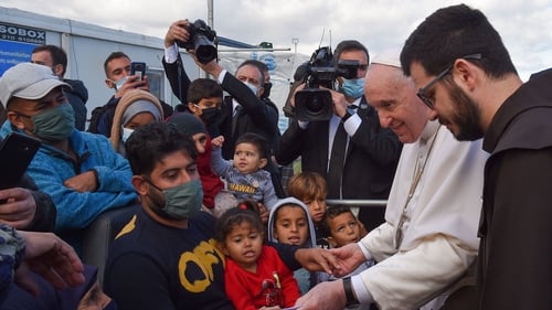 Pope Francis speaks to children who lined up to meet him on the island of Lesbos