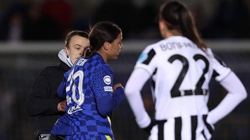 Chelsea's Sam Kerr stops a pitch invader.