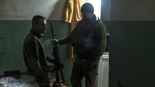 Ukrainian soldiers in a building on the front line near the border with Russia