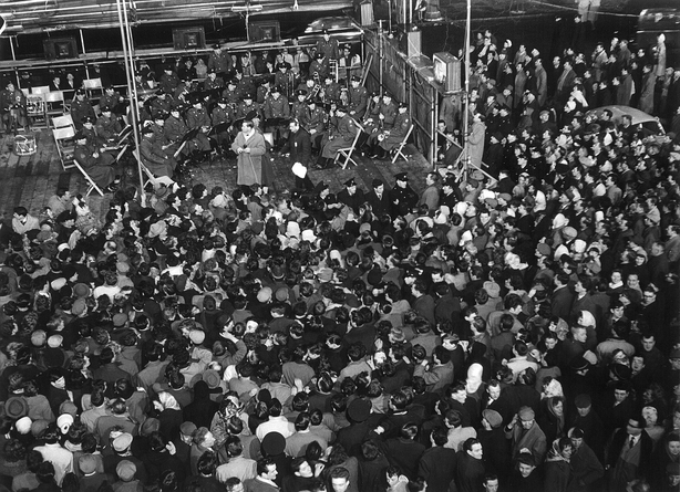 The Army No 1 Band and Irish singer Patrick O'Hagan, perform to a crowd outside the Gresham Hotel on Dublin's O'Connell Street on Telefís Éireann's opening night, New Year's Eve 1961.