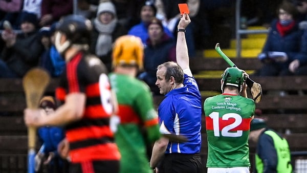 Referee Johnny Murphy shows the red card to Noel McGrath of Loughmore-Castleiney