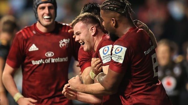 Scott Buckley (centre) is congratulated after scoring Munster's bonus-point try