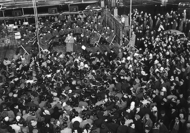 The Army No 1 Band and Irish singer Patrick O'Hagan, perform to a crowd outside the Gresham Hotel on Dublin's O'Connell Street on Telefís Éireann's opening night, New Year's Eve 1961. Lensmen & Associates