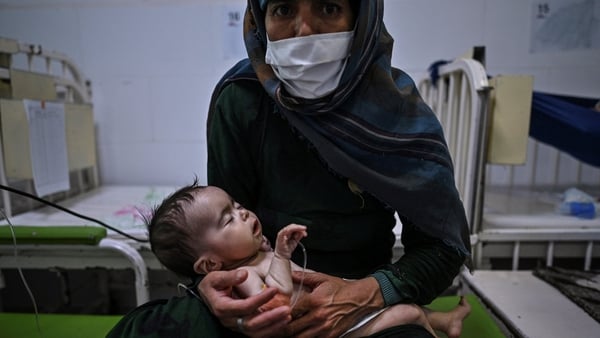 Edi Maa holds her baby receiving treatment for malnutrition at a MSF nutrition centre in Heart, Afghanistan