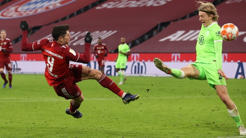 Robert Lewandowski scores the fourth goal in Bayern's rout of Wolfsburg