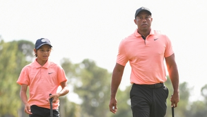 Tiger Woods and his son, Charlie Woods, walk off the third green