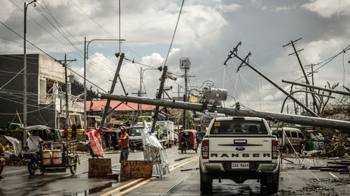 Fallen electric pylons block a road in Surigao City, Surigao del norte province