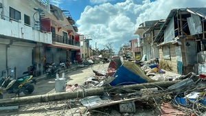 A handout photo made available by the Office of the Vice President of the Philippines shows a toppled electric post and debris along a road in the typhoon devastated town of General Luna, Siargao island