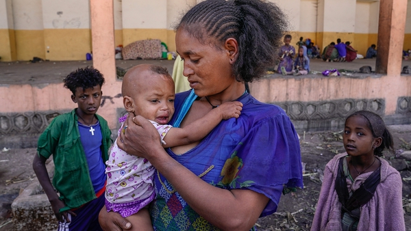 A mother from the Amhara region of Ethiopia comforts her child at the Zanzalima Camp for Internally Displaced People