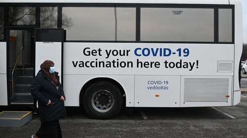 Members of the public receive their Covid-19 vaccine or booster at a NHS bus