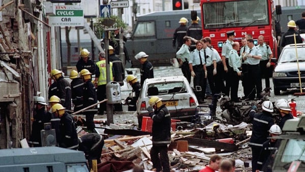 RUC officers and firefighters inspect the damage after the Omagh bomb in 1998