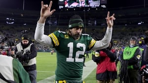Aaron Rodgers #12 of the Green Bay Packers walks off the field after beating the Cleveland Browns