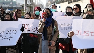Women hold placards during a protest in Kabul