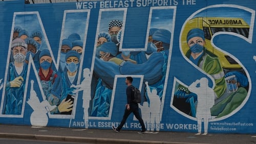 A man walks by a mural in west Belfast in support of the NHS (File)