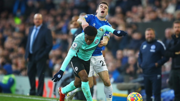 Seamus Coleman battles for possession with Tariq Lamptey as Benitez looks on
