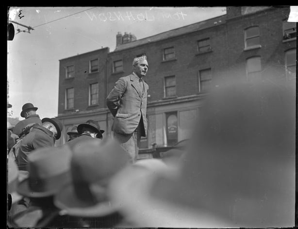 Black and white photo of Tom Johnson giving a speech in College Green 