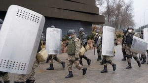 Riot police officers patrol the streets in Almaty
