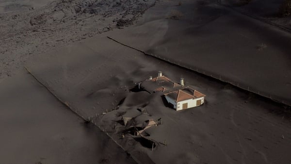 A house covered with lava and ashes following the eruption of the Cumbre Vieja volcano on the Canary Island of La Palma