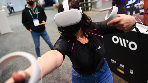 An attendee demonstrates the Owo vest at CES 2022 in Las Vegas