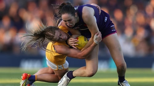 Isabella Lewis of the Eagles tackles Aine Tighe (R) of the Dockers.