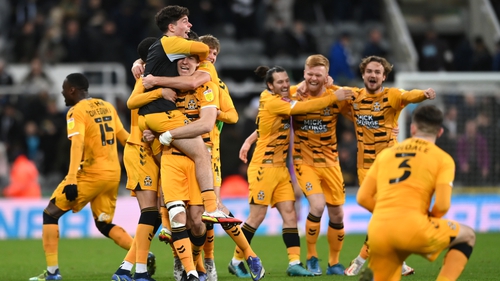 Cambridge players celebrate their cup upset on Tyneside