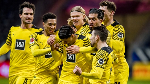 Mahmoud Dahoud is mobbed by his Borussia Dortmund teammates after scoring a crucial winner.