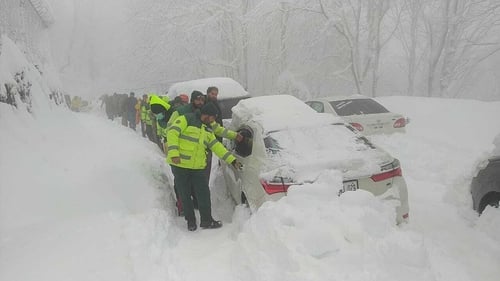 Army and civil rescuers work to rescue tourists stranded after heavy snow storm in Murree