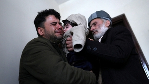 Hamid Safi (L), the taxi driver who had found baby Sohail at the airport, cries as he hands over Sohail to his grandfather