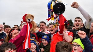 Pádraig Pearses joint-captain Emmett Kelly holds the cup aloft during the post-match celebrations.