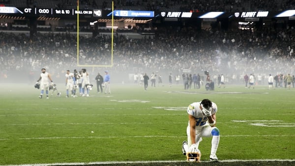 Los Angeles Chargers safety Alohi Gilman bends to one knee after the devastating overtime loss to the Las Vegas Raiders