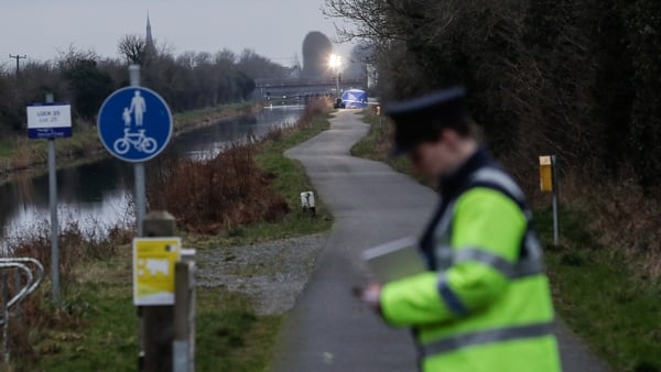 A Garda takes notes beside the Grand Canal in Tullamore, Co Offaly, where Aisling Murphy was murdered on Wednesday