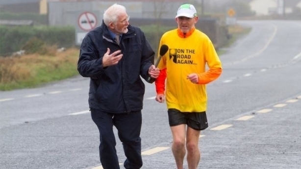 Jim Fahy interviewing a man on the road