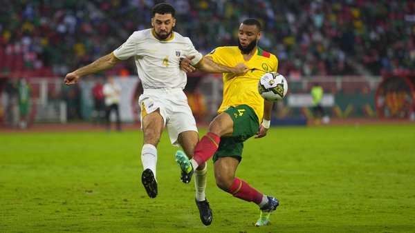 Roberto Lopes clears the danger as Harold Moukoudi goes on the attack for Cameroon