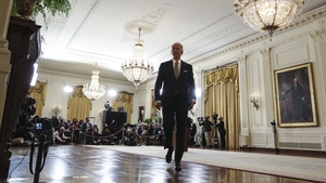 Joe Biden departs after speaking during a press conference in the East Room of the White House last night