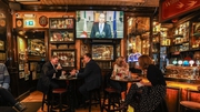Members of the public enjoy a drink as they watch the Taoiseach Micheál Martin on the television (Photo: RollingNews.ie)