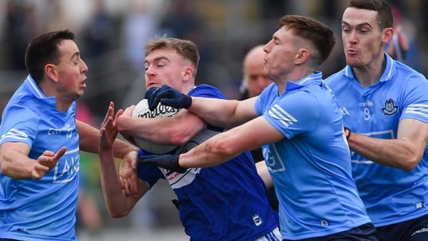 Seán O'Flynn is closed down by Cormac Costello, John Small, and Brian Fenton
