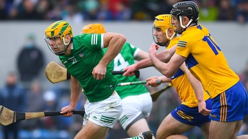 Dan Morrissey of Limerick is tackled by Cathal Malone of Clare