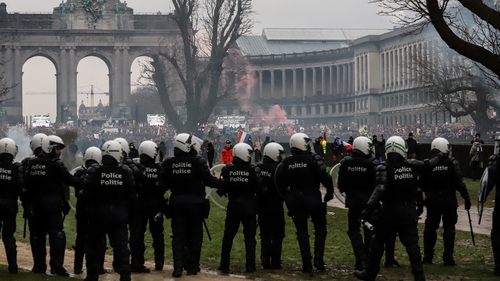 Police confront demonstrators during the protest against Covid-related measures in Brussels, Belgium