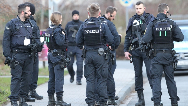 Police confer near the crime scene on the campus of the University in Heidelberg, Germany