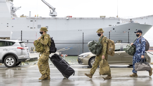 Australian Defence Force (ADF) personnel preparing to embark on HMAS Adelaide at the Port of Brisbane