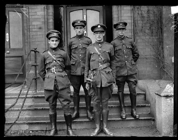 Sergeant Finian O Driscoll, Volunteer Factna O Driscoll, Quartermaster Sergeant Sean Powell, and Volunteer Michael Powell, circa 1922. The soldiers exact identification is unclear. They are four nephews of Michael Collins who served as Commander-in-Chief in the Free State Army.