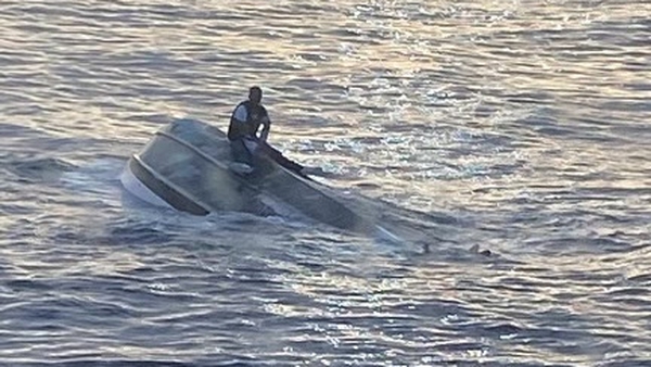 A man was found clinging to the upturned hull of the boat (Pic: @USCGSoutheast)