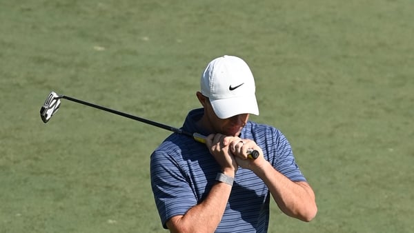 Rory McIlroy reacts to a bogey at the ninth hole