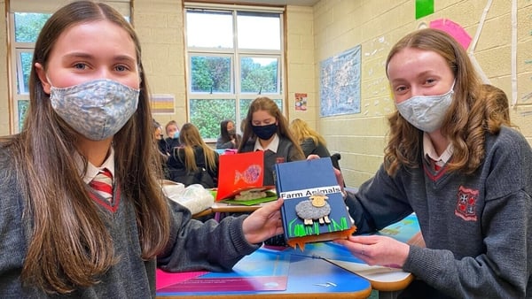 Two transition year pupils in Loreto College, Bray, holding the book they made