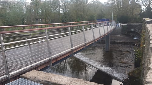 The new footbridge is located beside the existing - and protected - road bridge